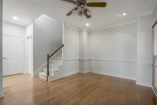 empty room with hardwood / wood-style floors, ceiling fan, and ornamental molding