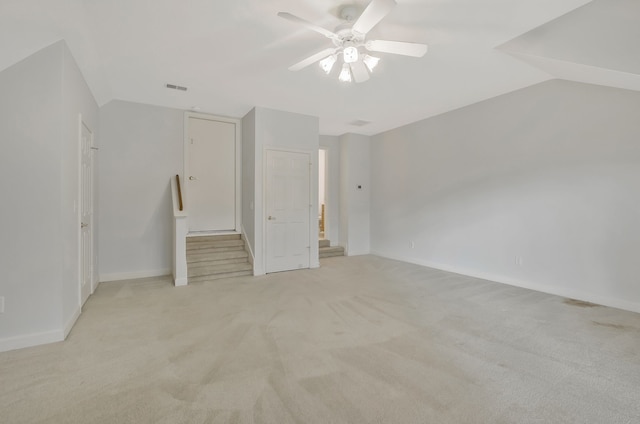 unfurnished bedroom with ceiling fan, light carpet, and vaulted ceiling