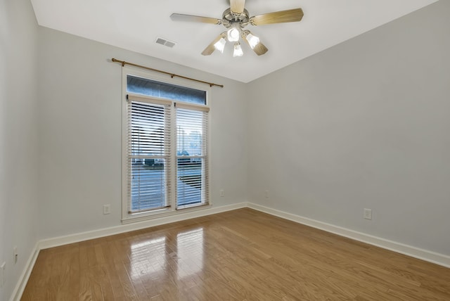 spare room featuring light wood-type flooring and ceiling fan