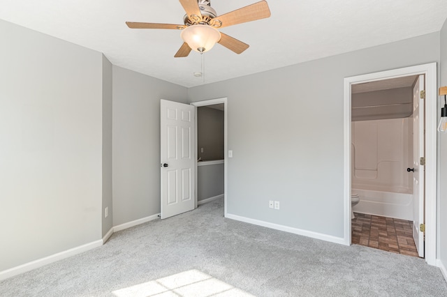 unfurnished bedroom with ceiling fan, light carpet, and ensuite bath