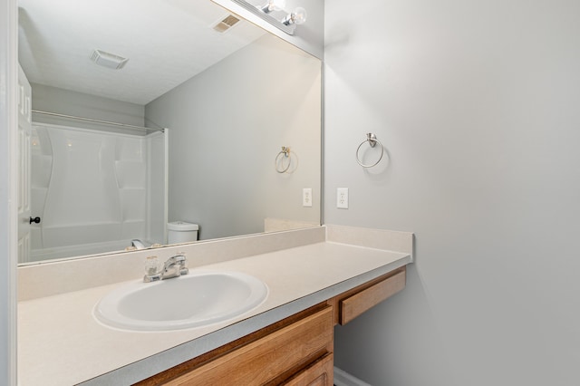 bathroom featuring toilet and vanity