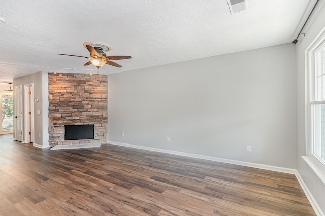 unfurnished living room with a textured ceiling and plenty of natural light