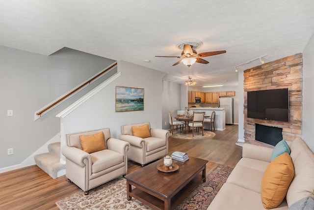 living room featuring light hardwood / wood-style floors and ceiling fan