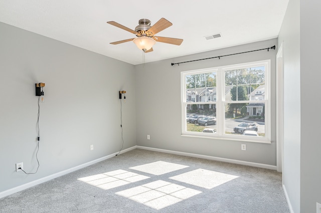 unfurnished room featuring ceiling fan and light colored carpet