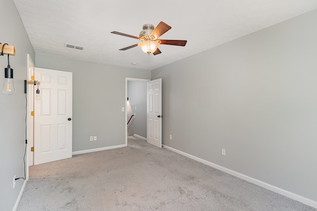 unfurnished bedroom with light carpet and ceiling fan