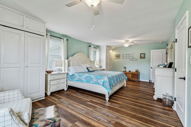 bedroom with a closet, dark hardwood / wood-style floors, and ceiling fan