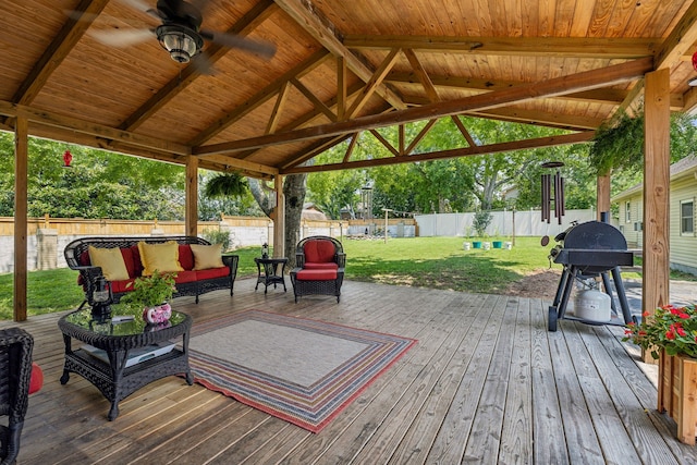 deck featuring a gazebo, an outdoor hangout area, a yard, and area for grilling