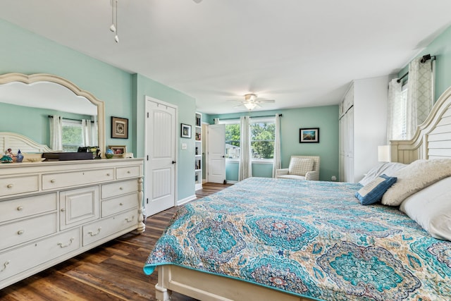 bedroom with a closet, dark hardwood / wood-style floors, and ceiling fan