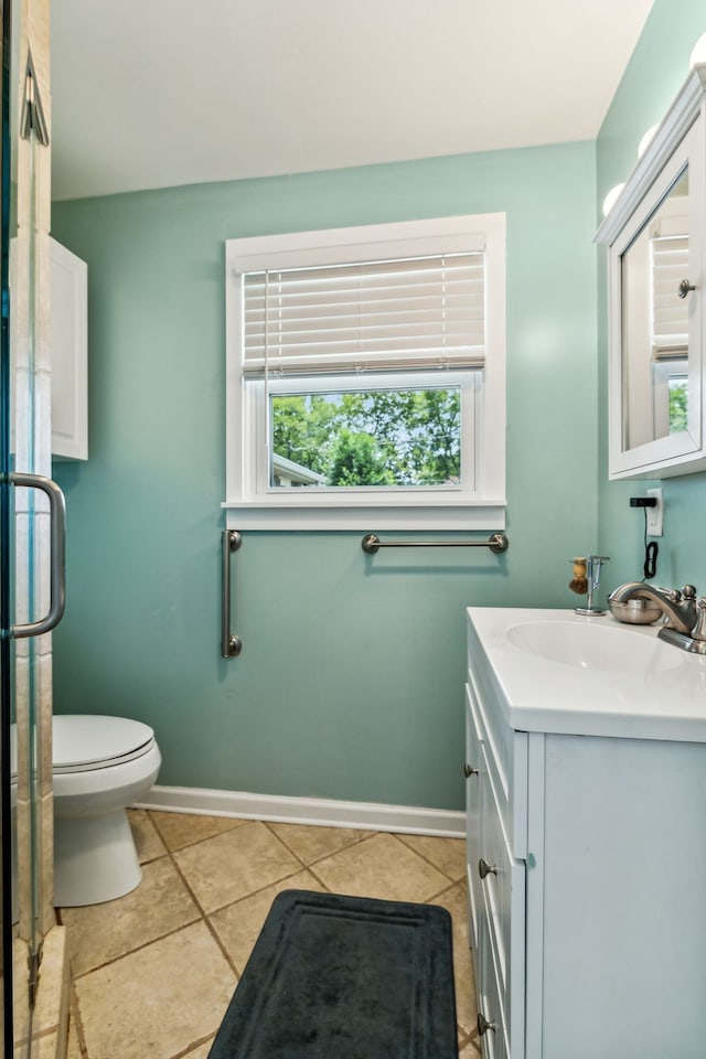 bathroom featuring vanity, toilet, and tile patterned flooring