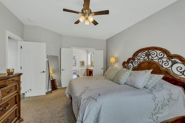 bedroom with ensuite bath, lofted ceiling, light carpet, and ceiling fan