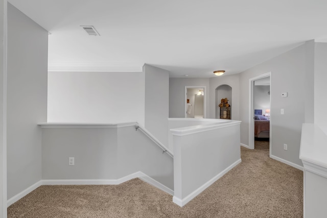 hallway featuring light carpet