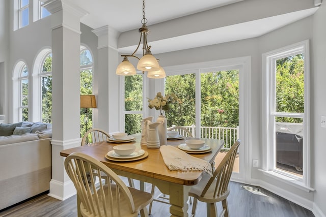 sunroom / solarium with decorative columns and an inviting chandelier