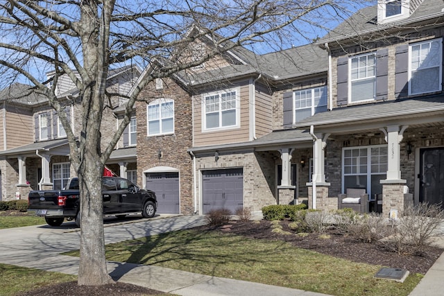 multi unit property featuring a garage and a porch