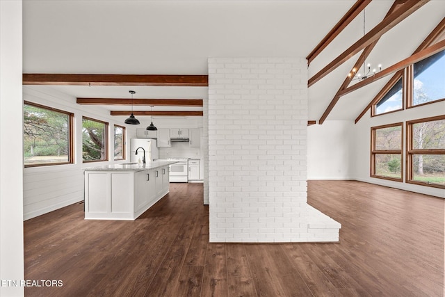 interior space featuring hanging light fixtures, white cabinetry, dark wood-type flooring, white range with electric stovetop, and lofted ceiling with beams