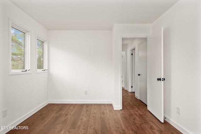 spare room with hardwood / wood-style flooring