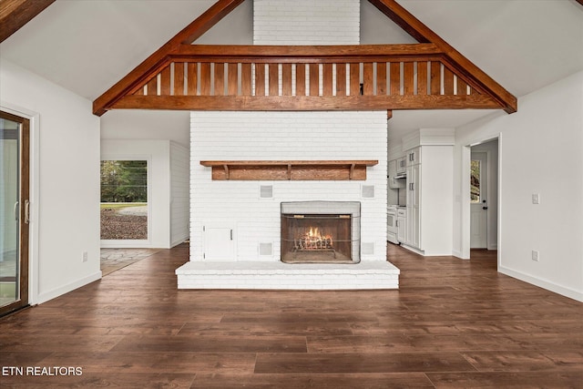 unfurnished living room with high vaulted ceiling, dark hardwood / wood-style flooring, and a fireplace