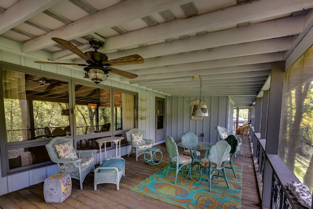 sunroom with ceiling fan and beamed ceiling