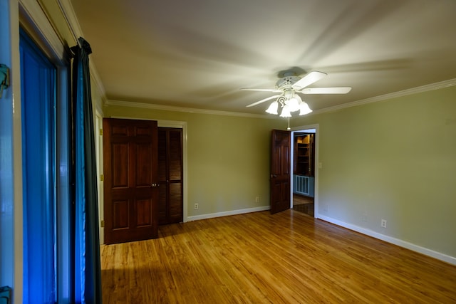 unfurnished bedroom with a closet, ceiling fan, ornamental molding, and light hardwood / wood-style flooring