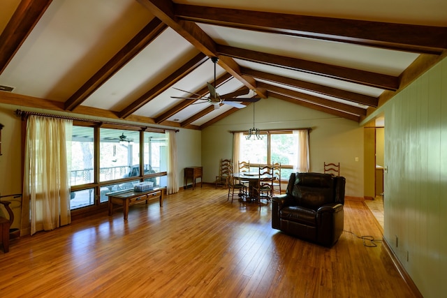 living room featuring light hardwood / wood-style floors, vaulted ceiling with beams, and ceiling fan with notable chandelier