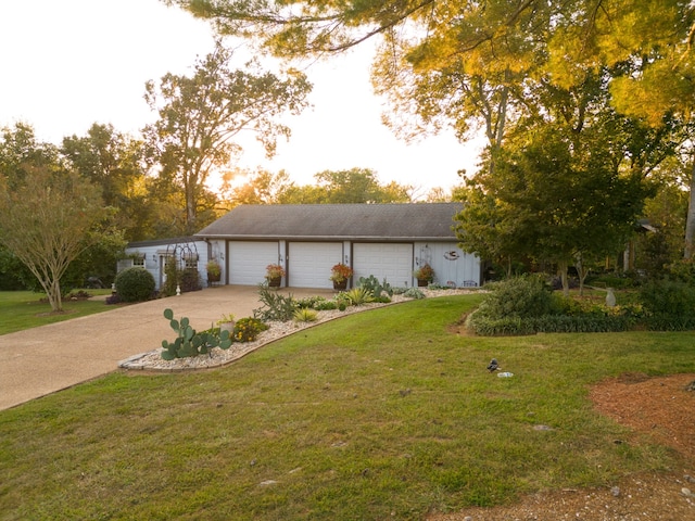 single story home with a front yard and a garage