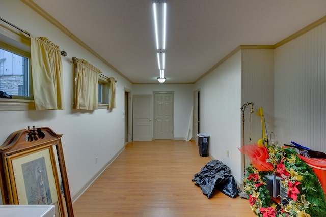 hall with ornamental molding and light wood-type flooring