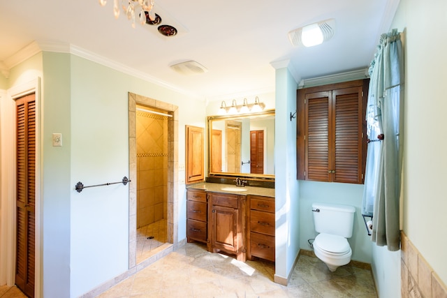 bathroom with a shower, toilet, ornamental molding, vanity, and tile patterned flooring