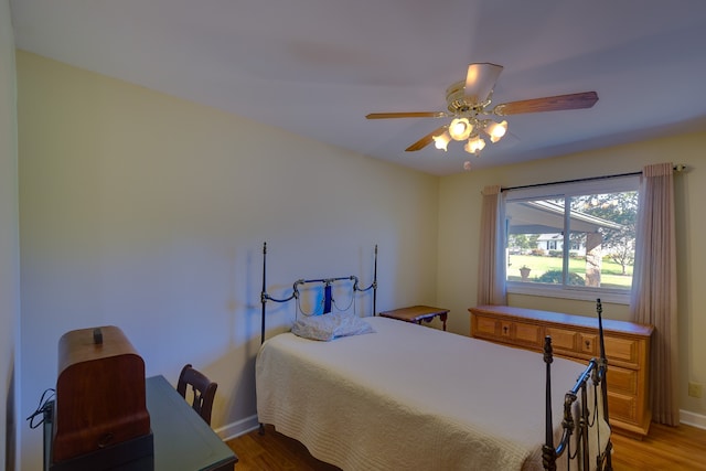 bedroom with ceiling fan and wood-type flooring