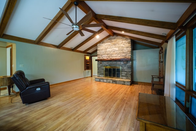 unfurnished living room with vaulted ceiling with beams, a fireplace, wood-type flooring, and ceiling fan