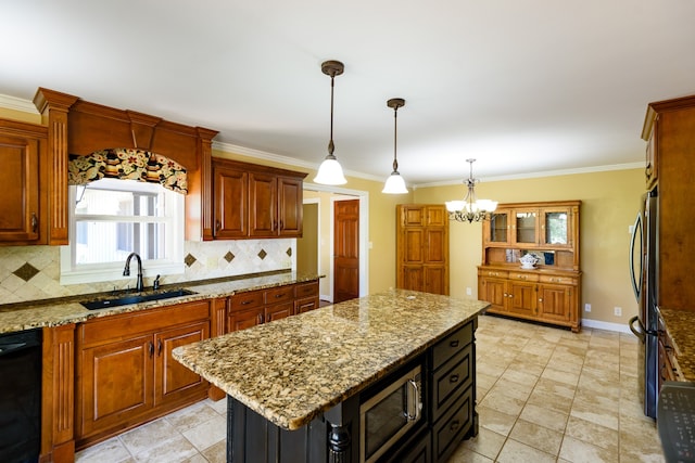 kitchen with light stone countertops, sink, a kitchen island, backsplash, and stainless steel appliances