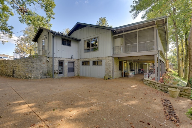 back of house featuring a sunroom and a patio area