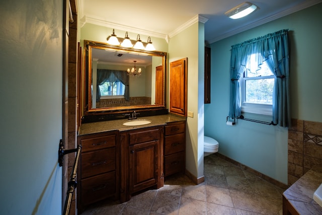 bathroom featuring vanity, ornamental molding, toilet, and plenty of natural light