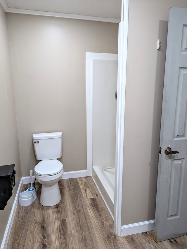 bathroom with toilet and hardwood / wood-style flooring