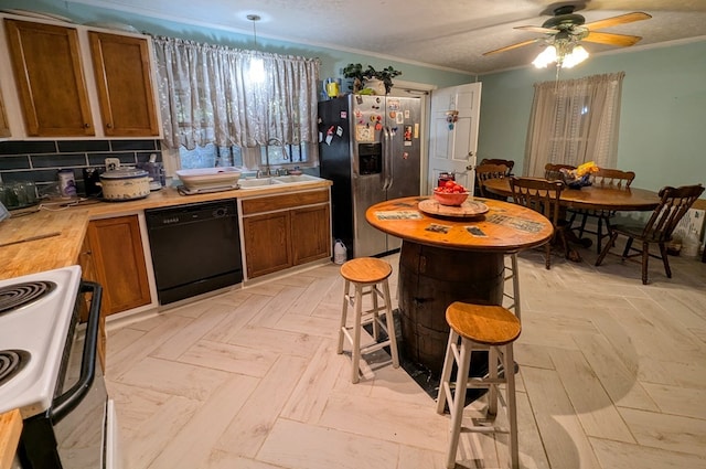 kitchen with dishwasher, stainless steel fridge, pendant lighting, white range with electric stovetop, and decorative backsplash