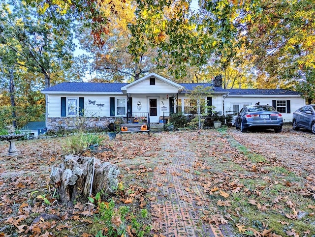 single story home featuring covered porch