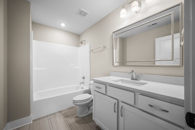 full bathroom with toilet, vanity, and washtub / shower combination