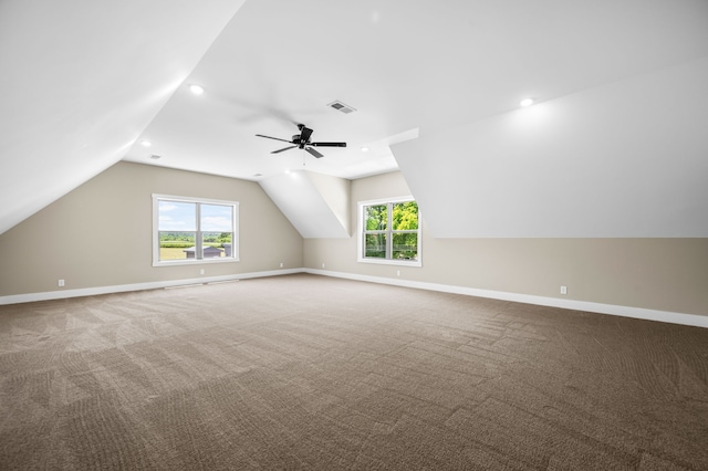 bonus room featuring lofted ceiling, carpet, and plenty of natural light