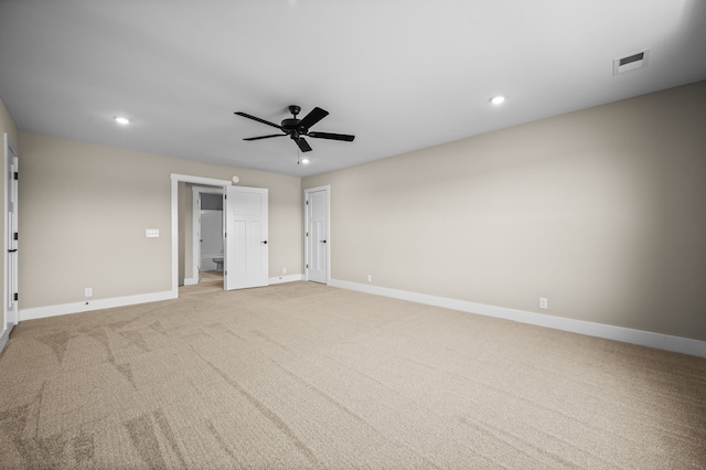 unfurnished bedroom with ceiling fan and light colored carpet