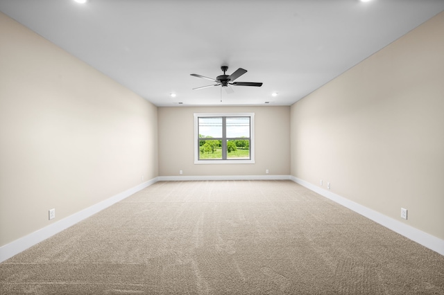 unfurnished room featuring light carpet and ceiling fan