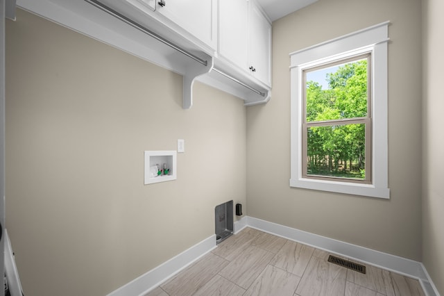 laundry area with washer hookup and cabinets