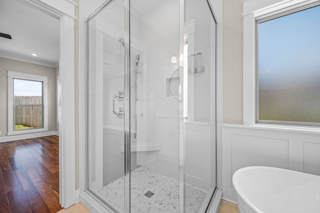 bathroom with shower with separate bathtub and hardwood / wood-style floors