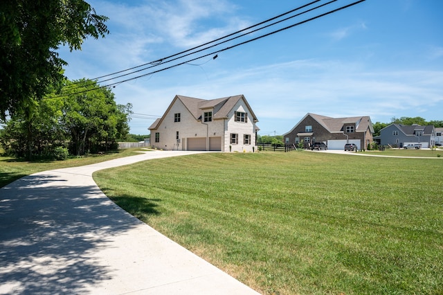 view of front of property featuring a front lawn and a garage