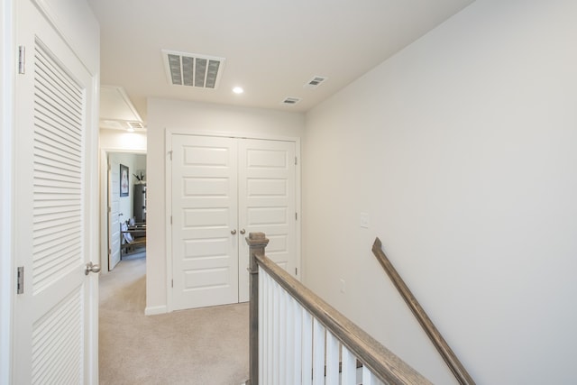 hallway with light carpet