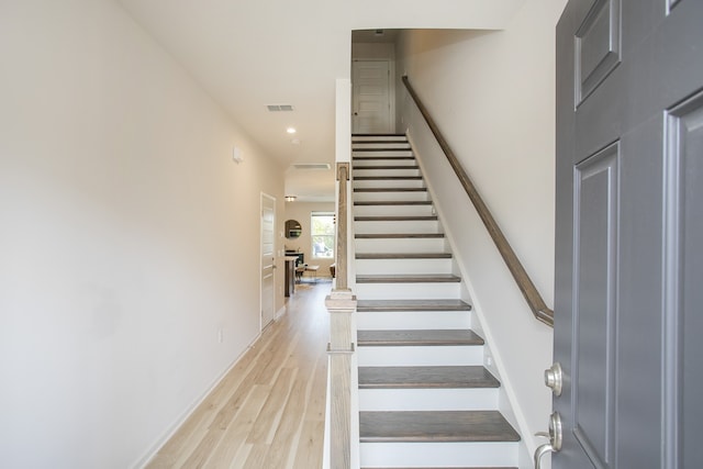 stairs featuring wood-type flooring