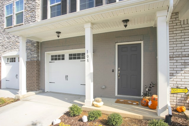 property entrance with covered porch and a garage