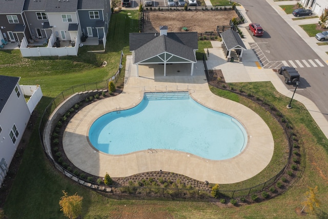 view of swimming pool featuring a patio and a lawn