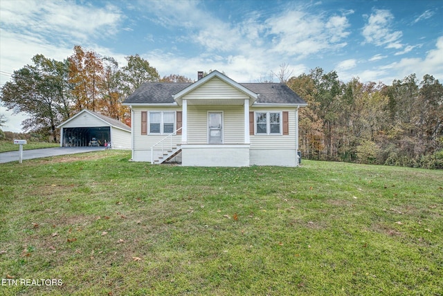 view of front of home with an outdoor structure, a front yard, and a garage