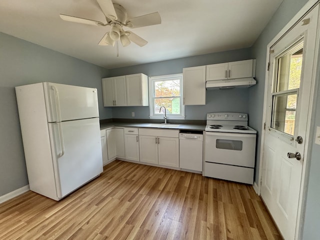 kitchen featuring a wealth of natural light, white cabinets, light hardwood / wood-style flooring, and white appliances