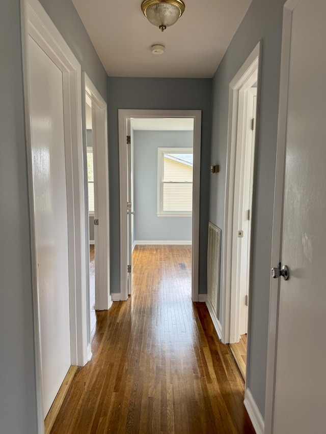 corridor featuring dark hardwood / wood-style floors