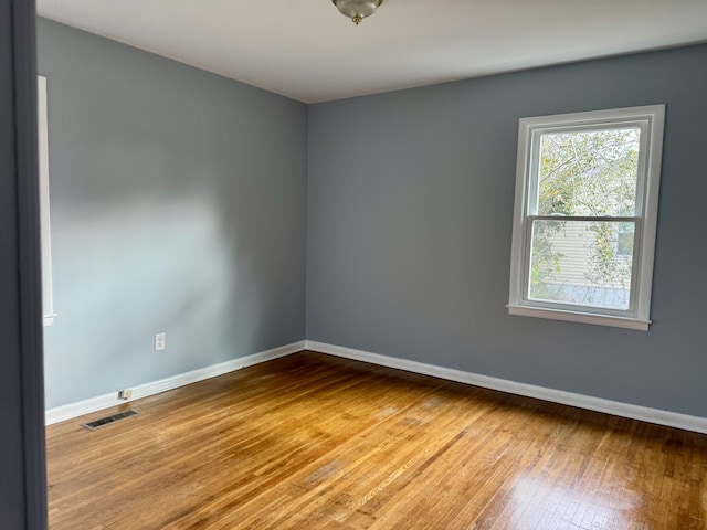 empty room with wood-type flooring