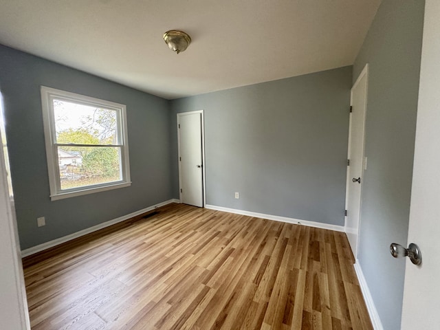 unfurnished room with light hardwood / wood-style flooring